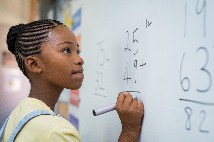 Child Writing on Whiteboard